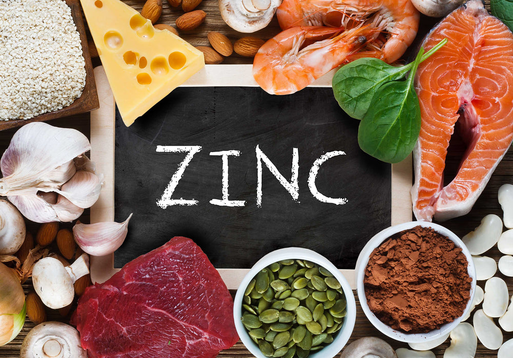 "ZINC" written on a chalkboard surrounded by food A