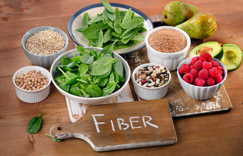 "Fiber" written on a board surrounded by fruits, vegetables, and grains 1