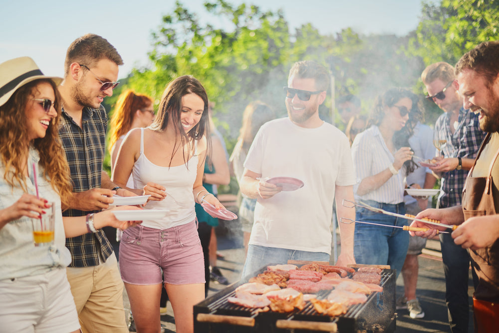 Group of people around a grill