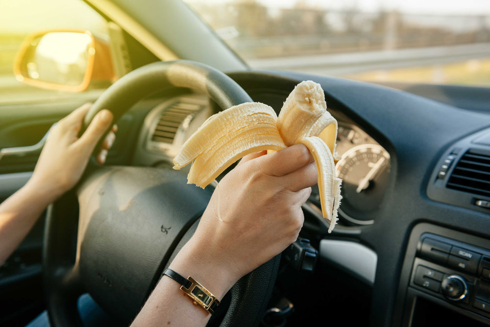 Person eating a banana while driving 1